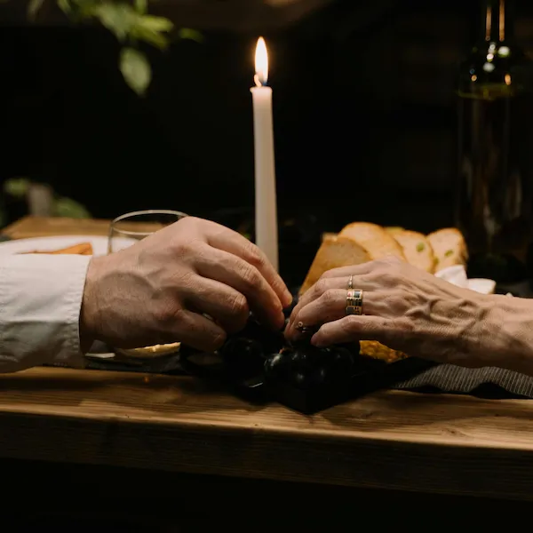A couple sharing a candlelit dinner