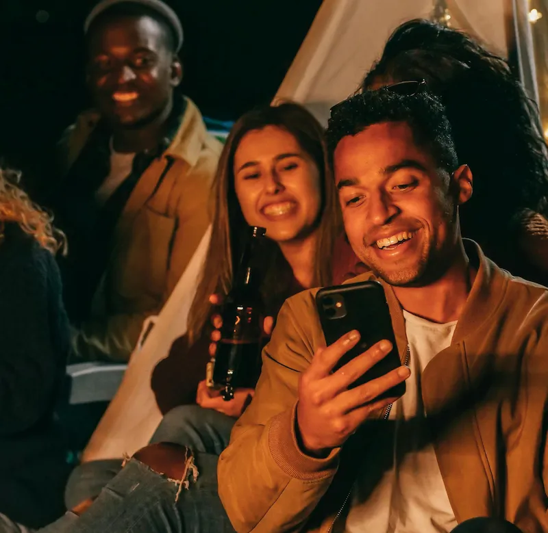 A group of friends laughing together at night